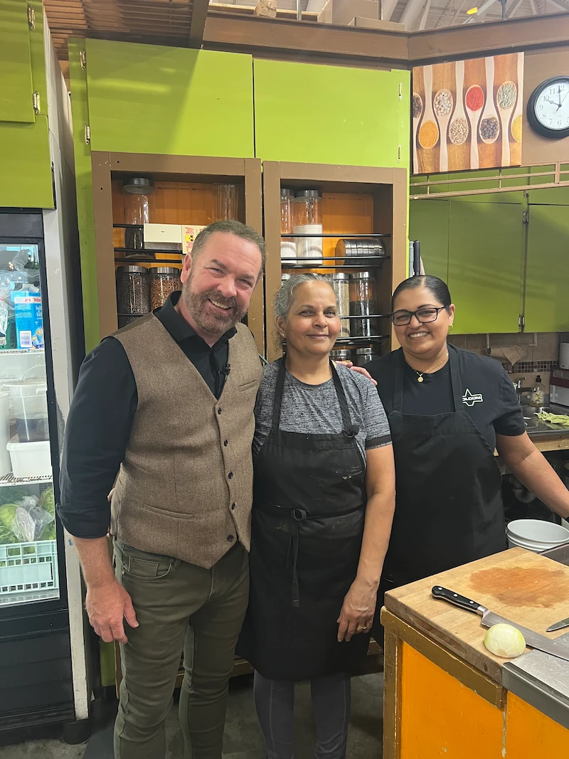 host standing with owner